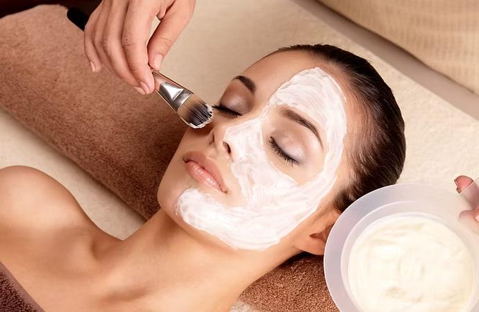 A facial mask being applied with a brush